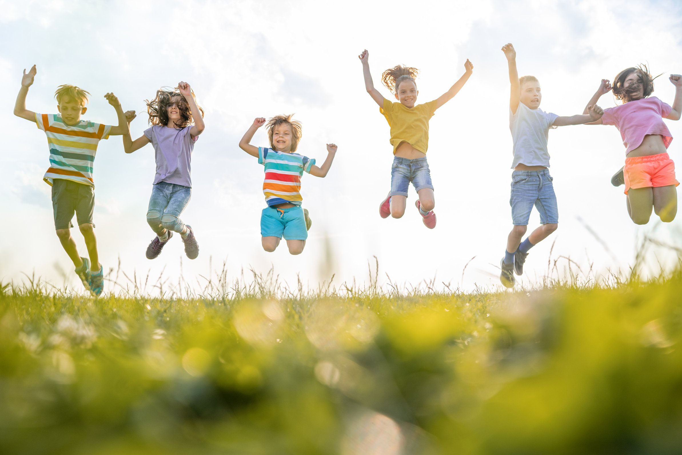 Group of kids jumping in nature